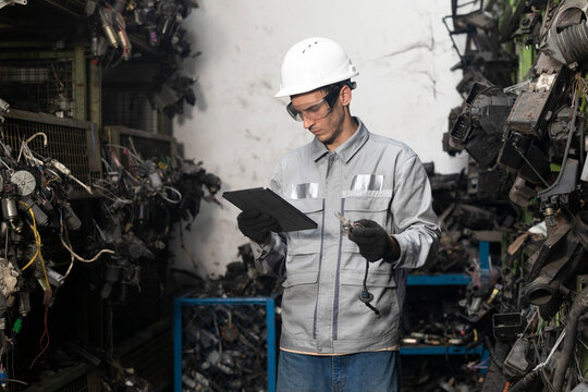 Professional adult Engineer male work in factory working checking stock inventory data with tablet computer.