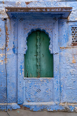 Jodhpur, India - March 29, 2024: An old door to a traditional blue house.