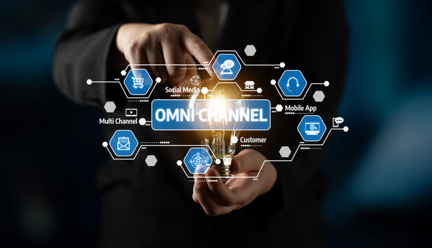 Professional hand holding a light bulb with digital icons representing omni-channel marketing strategies for businesses and customer engagement in a modern setting.. Tessel.