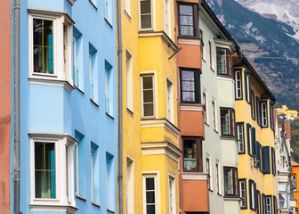 Row of colorful historic apartment buildings with glass windows in Innsbruck city, Austria