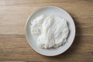 Thai rice noodle in white ceramic plate,thai called Khanom Jeen
