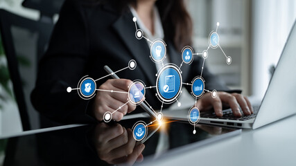 A businesswoman works on her laptop in a modern office, surrounded by digital marketing icons, representing online strategy development and innovative engagement. Tessel