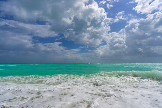 Tropical beach. Beautiful sea pattern. Clean water surface. Calm ocean motion. Dramatic storm waves. Sunlit seashore. Foamy wave texture. Clear turquoise sea. Serene holiday view. Wavy ocean.