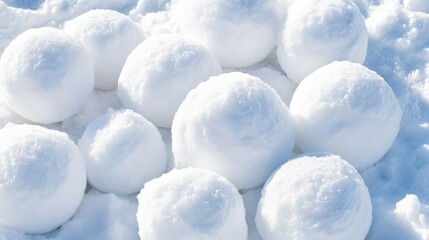Pile of pristine white snowballs on a glistening snowy surface, ready for winter fun and outdoor play
