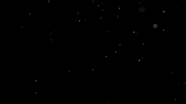 Abstract Slow Motion Dust Particles Floating and Falling Against a Dark Black Background, Ideal for Overlays and Visual Effects