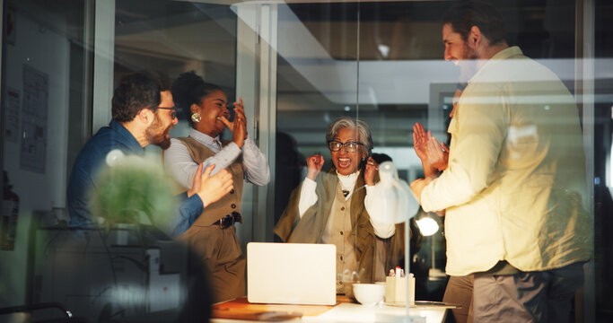 Promotion, applause and business people in meeting with success, winning or finance deal at night. Teamwork, clapping hands and group with laptop for celebration, achievement or financial funding - Powered by Adobe