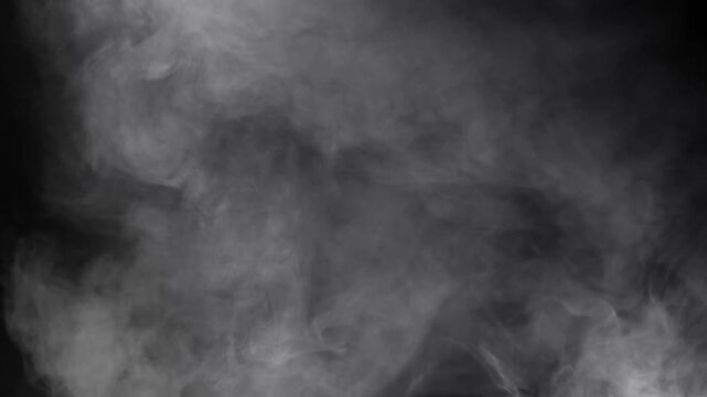 White smoke and fog effect with swirling, rising mist on a dark black background, ideal as a mysterious abstract atmospheric overlay
