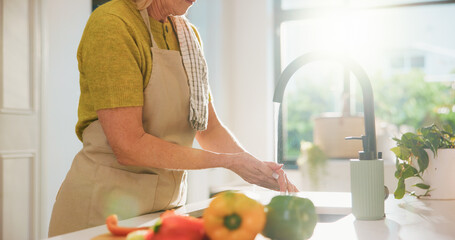 Washing hands, faucet and cooking in kitchen with vegetables, recipe and water for bacteria at home. Person, cleaning pepper and ingredients with prepare, diet or hygiene for nutrition in retirement