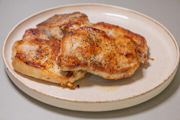 delicious cooked pork chops on white plate