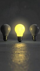 Lightbulb trio, one glows brightly