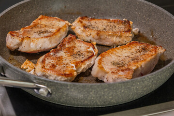 delicious cooked pork chop in a pan on the stove
