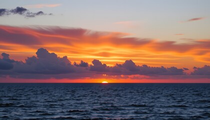 Obraz premium Stunning Sunset Over Calm Ocean Waves with Colorful Clouds on the Horizon at Dusk