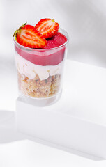 Fresh strawberry dessert in a clear cup with smooth layers and vibrant colors