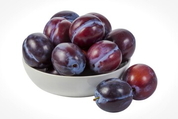 A fresh, ripe plums arranged in a white bowl