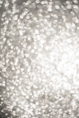 Silver Sparkling Lights Festive background with texture. Abstract Christmas twinkled bright bokeh defocused and Falling stars.