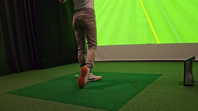 Golf practice indoors with high-tech simulator in a comfortable setting
