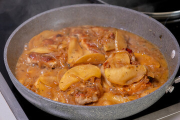 cooking pork chop with apples in a pan