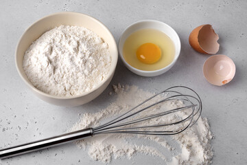 Baking Preparation with Flour, Egg, and Whisk