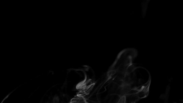 Abstract white smoke effect gracefully floating upwards on a solid black backdrop, ideal for compositing, visual effects, and atmospheric design.