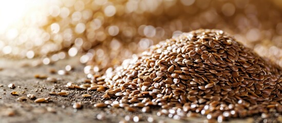 Obraz premium Close-up of a pile of brown flaxseeds on a wooden surface. The seeds are small, oval-shaped, and shiny, showcasing their natural texture and color.