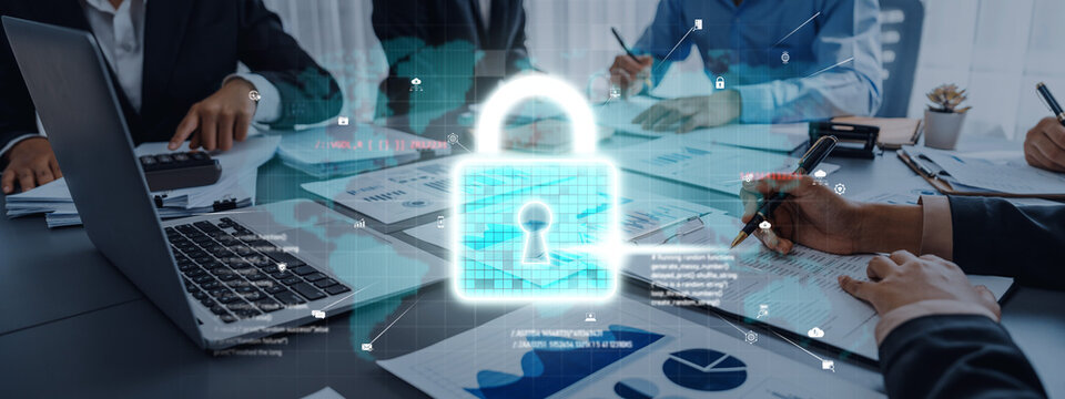 A business meeting focused on cybersecurity showcasing professionals discussing data protection strategies with a digital padlock symbol overlay representing security. Trope