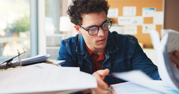 Multitask, stack or man in office with document, task or deadline pressure in management review. Busy, organize or marketing intern in agency with glasses, paper check or crisis control in time limit