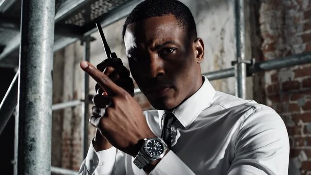 Man with walkie talkie serious expression urban setting dramatic lighting
