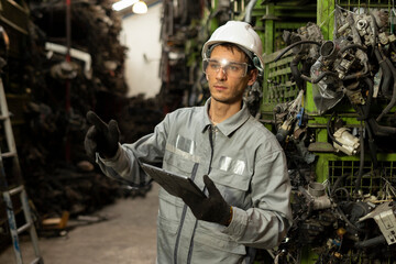 Technician worker working and checking in garage scrap yard car workshop warehouse.
