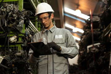 Technician worker working and checking in garage scrap yard car workshop warehouse.
