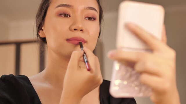 A beautiful woman poses and takes a selfie in front of a mirror after applying makeup. Stylish and confident look, perfect for beauty, lifestyle, fashion, and social media content