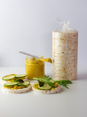 Crispy rice crackers package with spread and fresh cucumbers