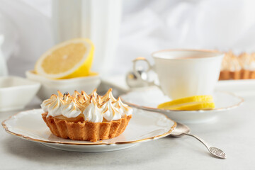 Meringue lemon tart on a white table.
