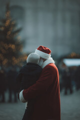 santa claus joyfully interacts with children in bustling shopping mall during holiday season