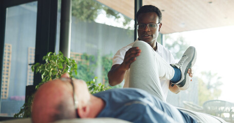 Leg, help and stretching with old man and physiotherapist for support, chiropractor and rehabilitation. Consulting, physical therapy and recovery with senior patient in clinic for healthcare