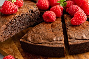 Decadent chocolate cake topped with fresh raspberries