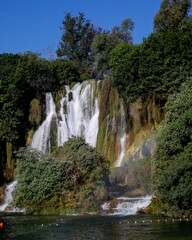 Fototapeta premium Kravitsa Cascades dance amid verdant whispers, evoking World Waterfall Day and Midsummer's misty embrace, vibrant nature's hidden lullaby