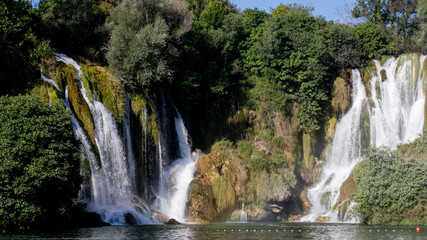 Obraz premium Kravitsa A cascade of enchanting waterfalls whispers tales of wonder, celebrating World Waterfall Day and invoking tranquility meditation