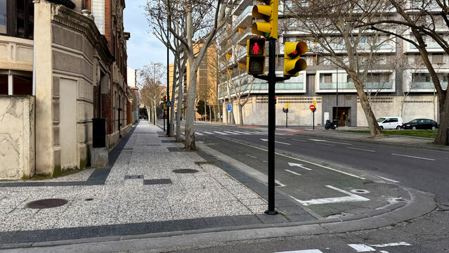 Silent urban crossroads await spring's Maypole dance, echoing solitary serenity, Intersectionality Day, and quiet urban introspection moments