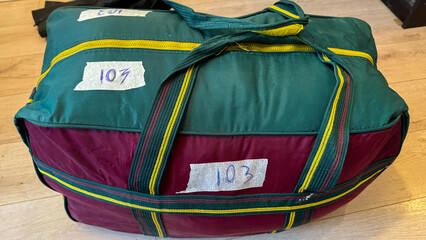 Vibrant travel bag whispers tales of forgotten journeys, evokes wanderlust tinged with nostalgia, perfect for International Luggage Day