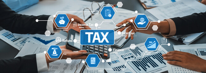 Two hands reaching for a calculator above tax documents, conveying themes of finance, planning, and the complexities of income tax management. Amity