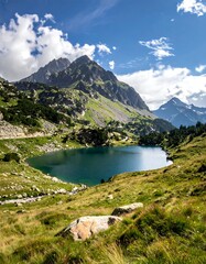 Naklejka premium A scenic mountain landscape features a serene lake reflecting the sky, framed by rolling hills and majestic peaks under a bright, sunny sky