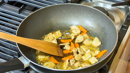 Sizzling wok marvel, chicken symphony with carrot crescents, Lunar New Year feast, culinary alchemy, tantalizing kitchen aroma
