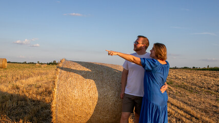 A couple in sun-kissed fields, Nordic whispers and harvest feats, celebrate Lughnasadhs embrace