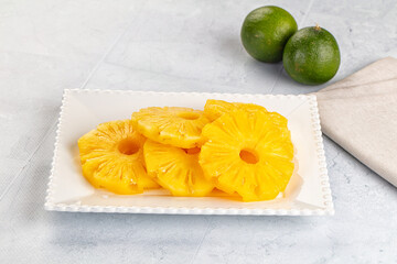 Sweet canned pineapple slices in syrope