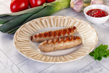 Grilled pork sausages served tomato sauce
