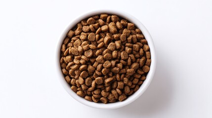 Fototapeta premium A white ceramic bowl filled to the brim with brown, rounded kibble, seen from a top-down angle on a white background. Perfect for showcasing wholesome pet nutrition and canine well-being.