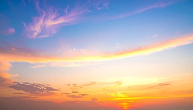 A vibrant skyscape showcases a gradient of colors from warm orange and yellow to cool blues and purples, soft clouds drift