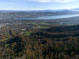 Fototapeta premium Aerial view of beautiful Swiss autumn landscape with city of Zürich seen from local mountain Uetliberg on a sunny autumn day. Photo taken October 29th, 2025, Zurich Uetliberg, Switzerland.