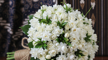 Exclusive bouquet made of Javanese jasmine flowers with green leaf accents