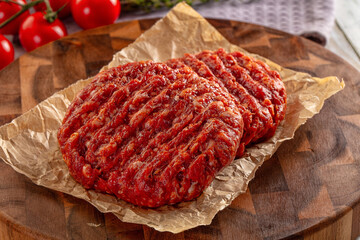 Raw uncoocked red beef round cutlet